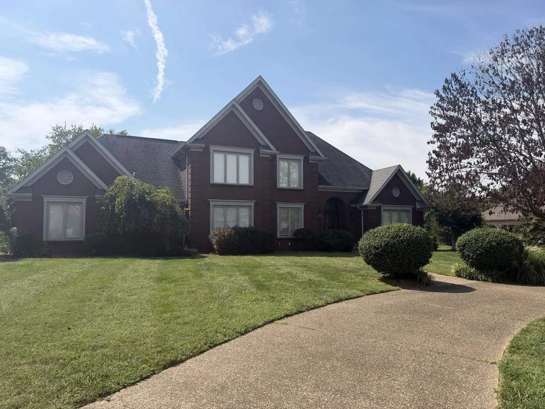 Original site photograph of a Kentucky brick home and landscape, documented for improvement planning